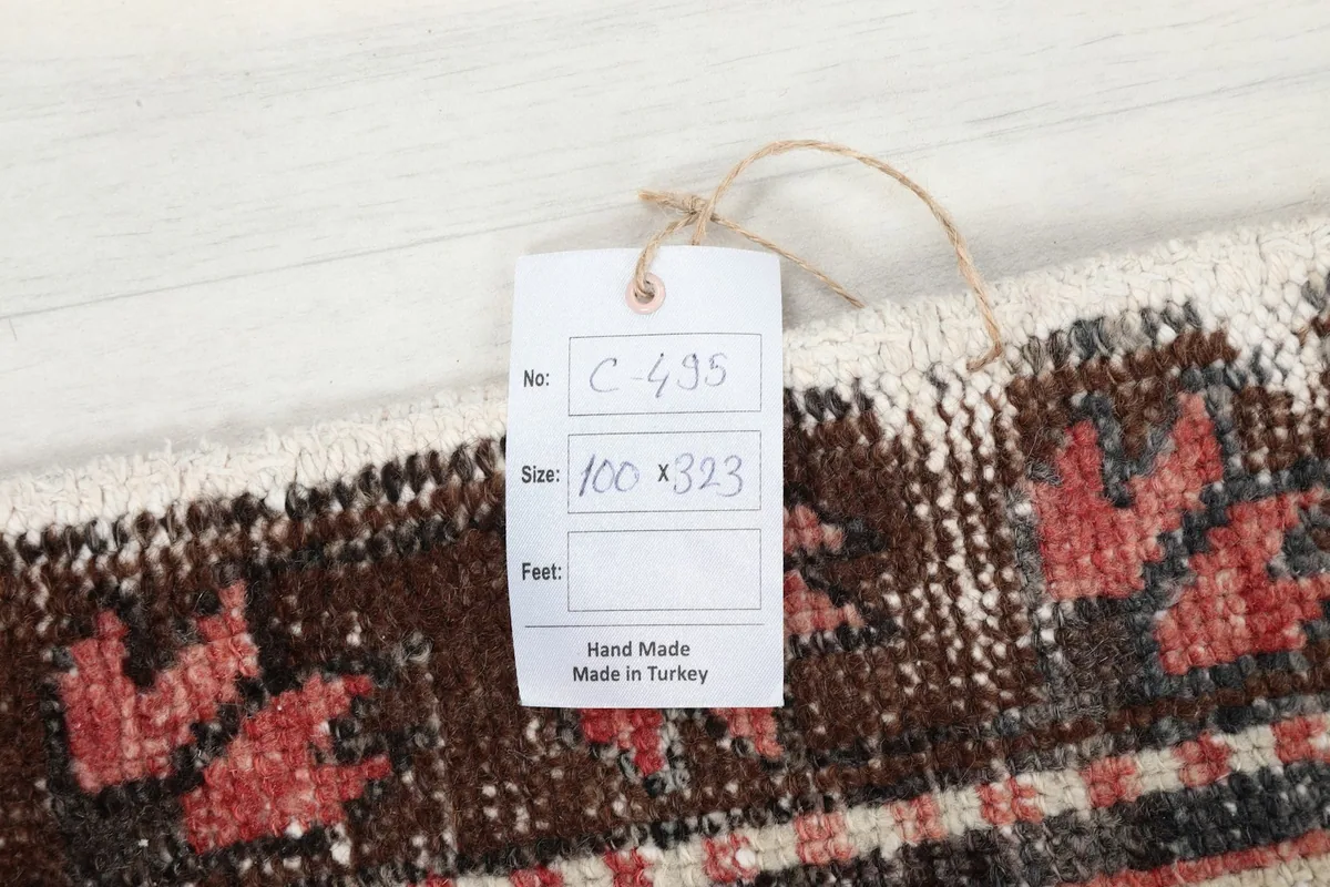 Close-up of a tag on the rug indicating it is hand-made in Turkey, with size details.