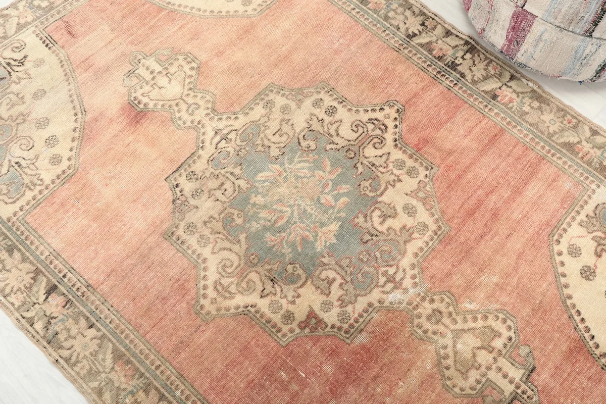 Close-up of the central blue and beige medallion with floral motifs