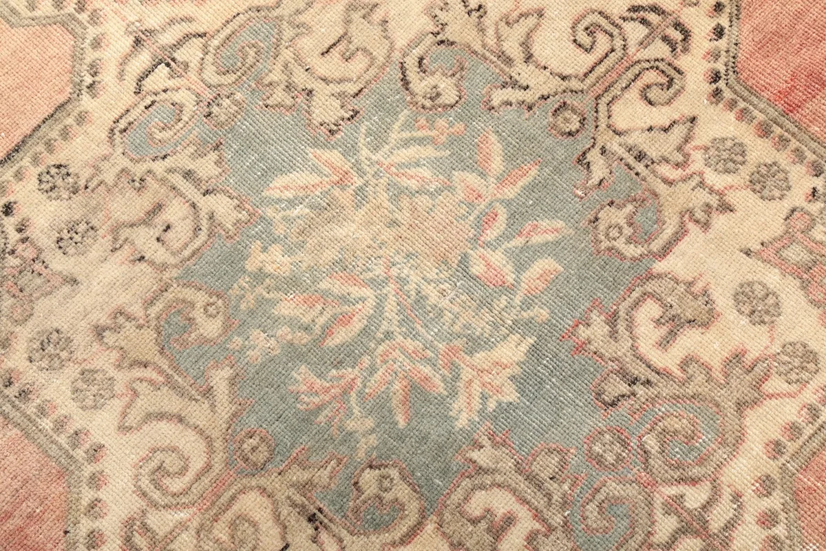 Detailed view of the intricate floral patterns within the medallion and surrounding elements