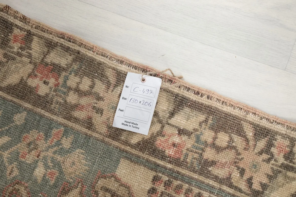 Close-up of the rug's corner with the product tag showing size and origin details