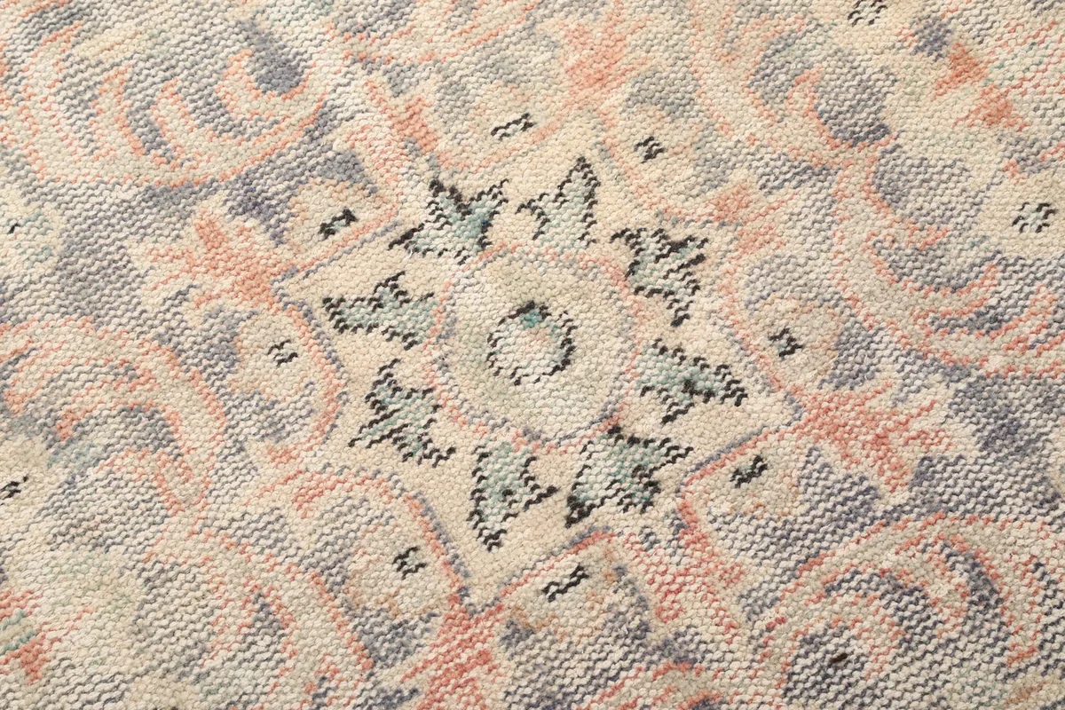 Close-up of a section of the central medallion, revealing the fine hand-knotted details and subtle color variations.