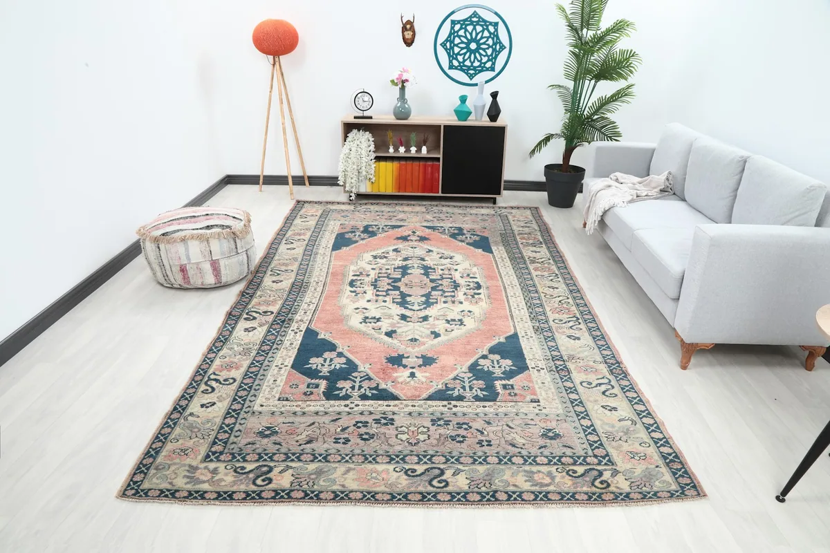 Vintage navy and rust medallion rug displayed in a modern living room setting