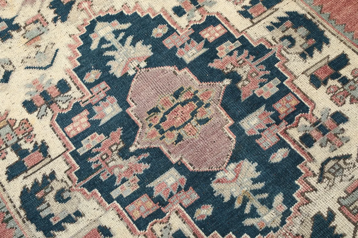 Close-up detail of the medallion's center with pink and cream geometric forms