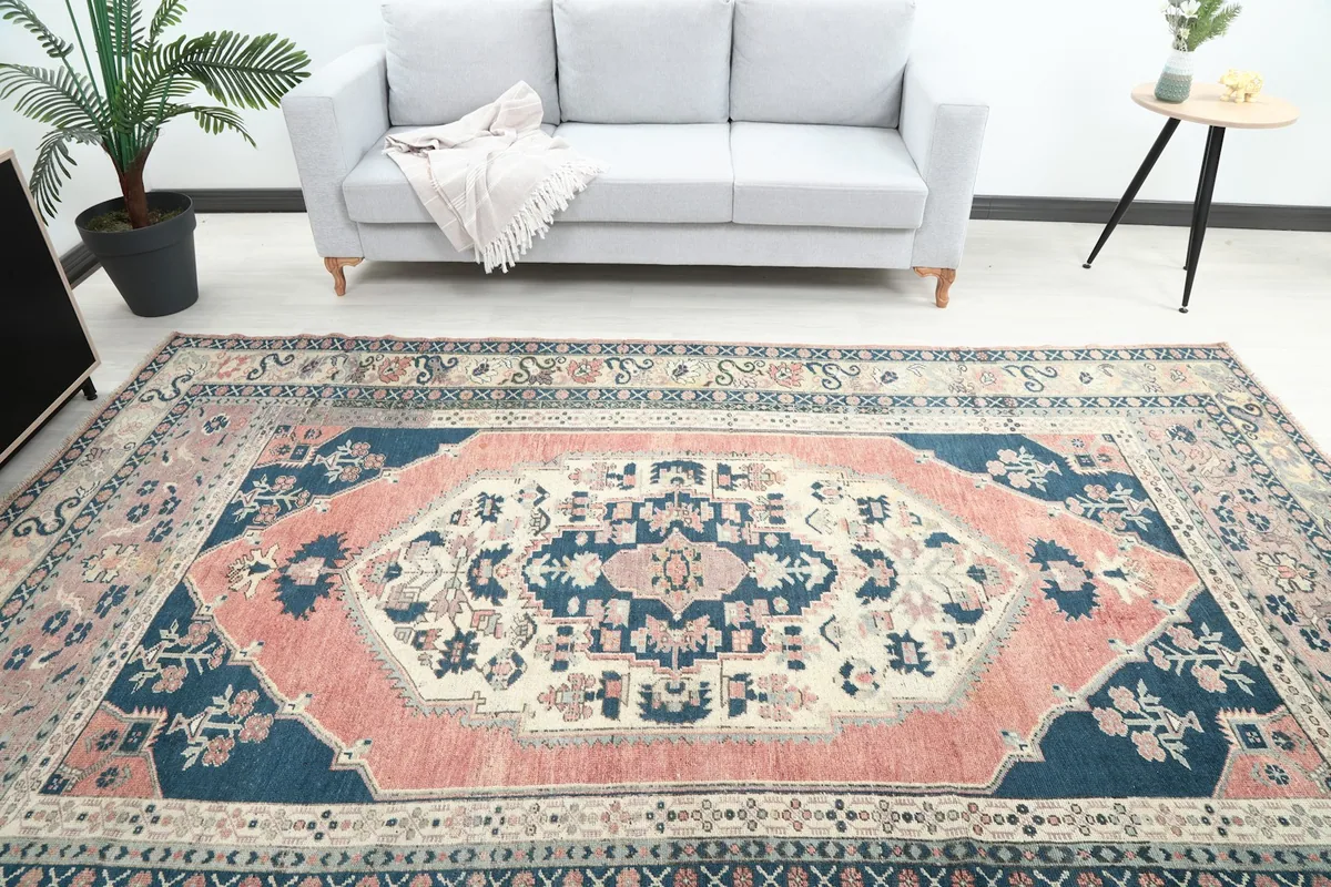 Overhead view of the vintage rug highlighting the central medallion and border details