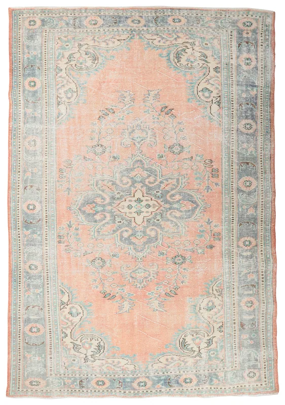 Full overhead view of the vintage Anatolian area rug with rose field and blue medallion