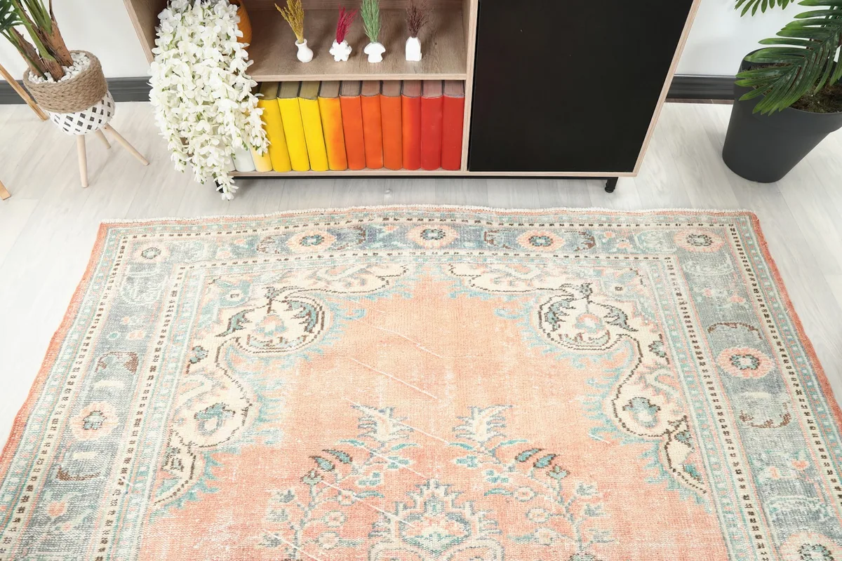 Detail of the top section of the vintage rug, showing the border and field patterns