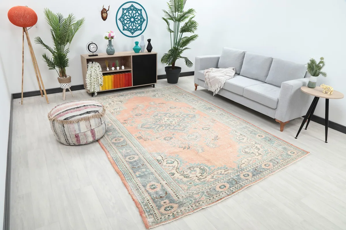Angle view of the rose and blue vintage rug in a modern living room