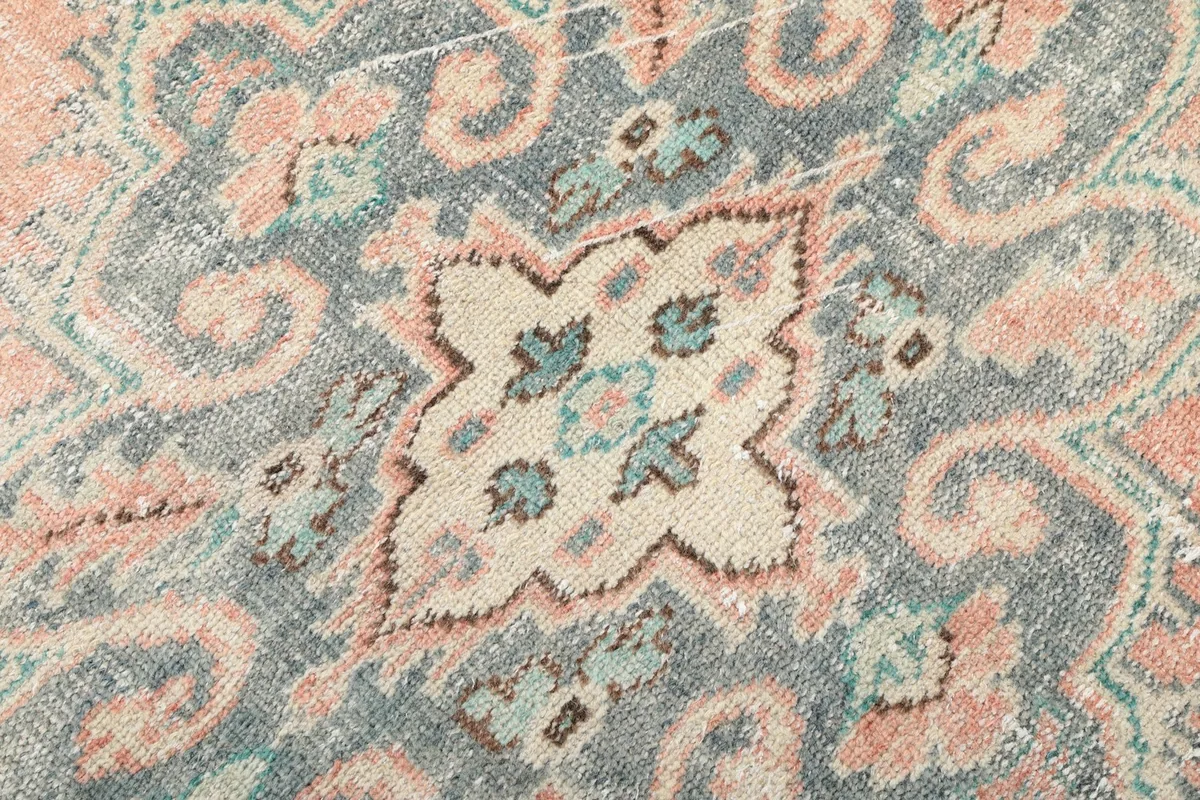 Extreme close-up of the intricate patterns and wool pile texture within the medallion