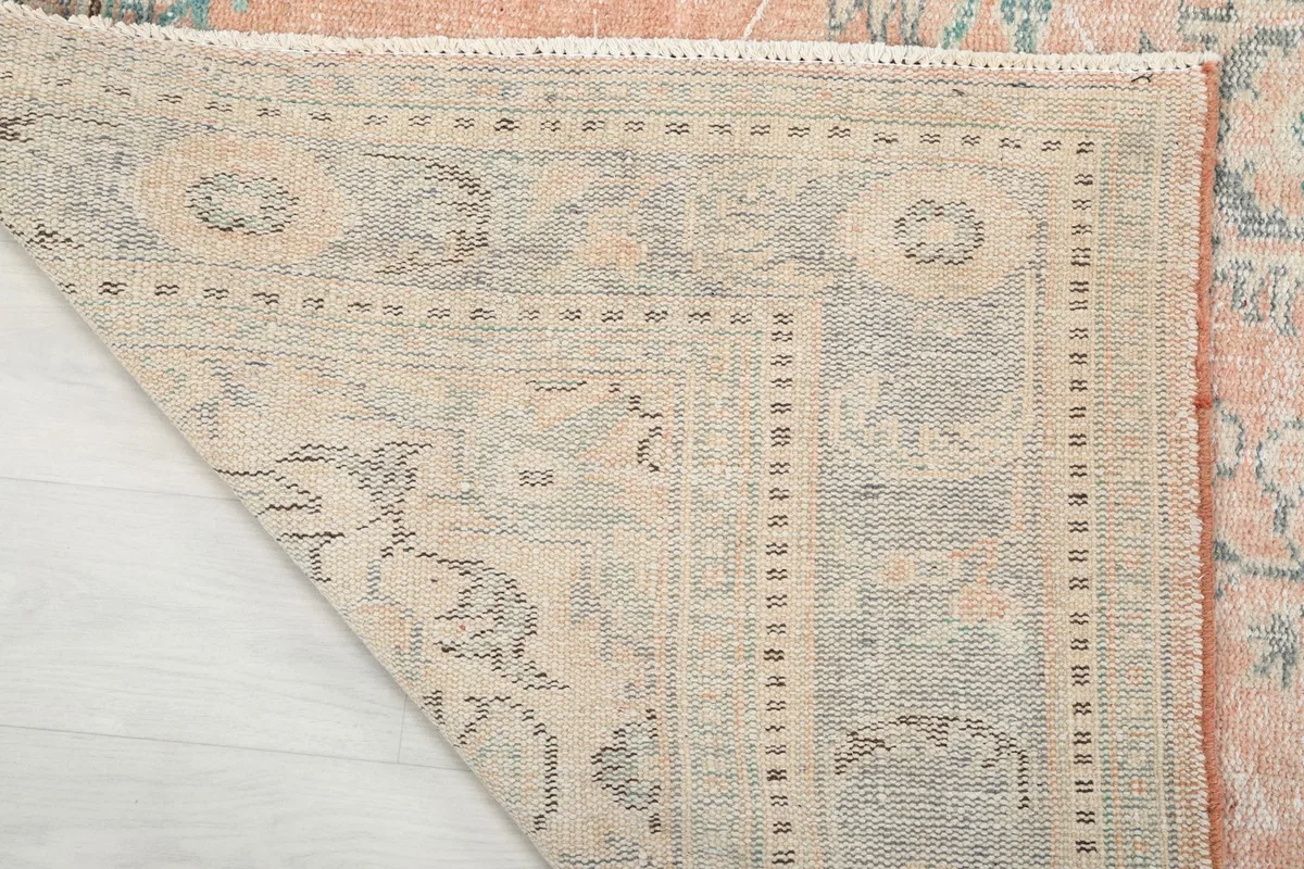Close-up of the rug's backside, revealing the cotton foundation and knotting