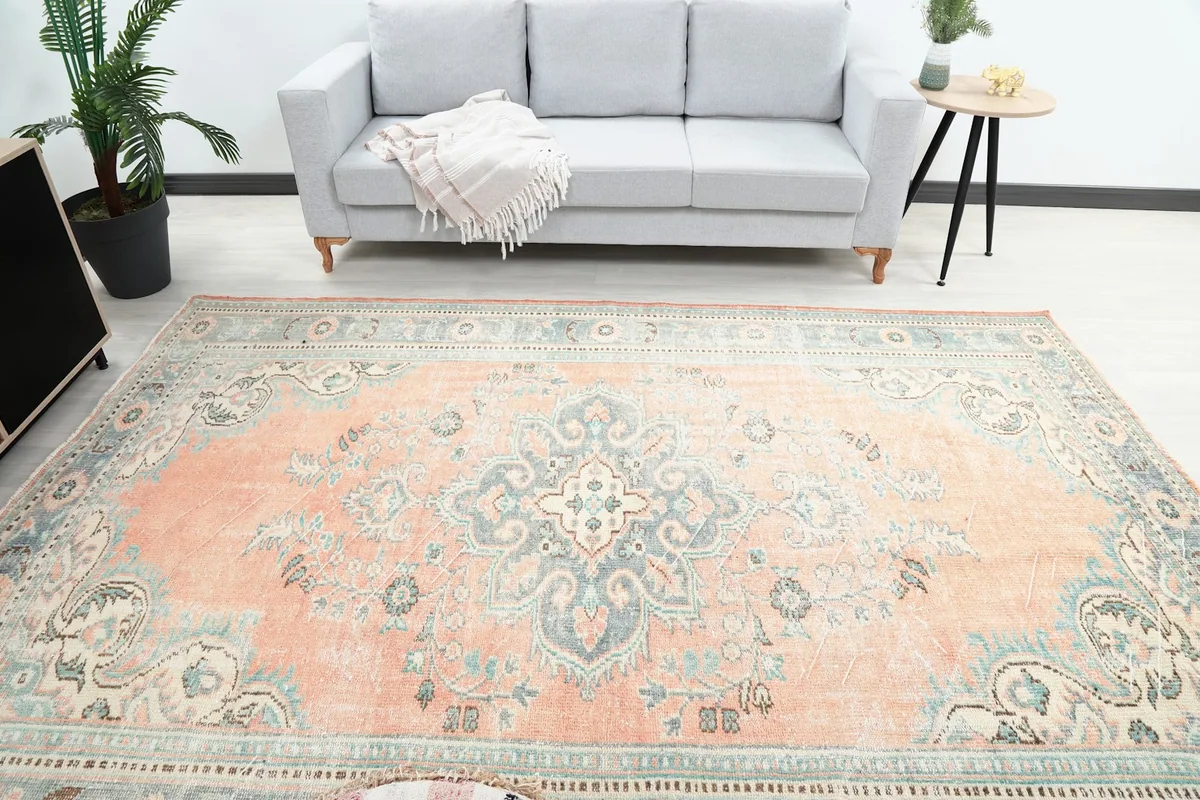 Overhead view of the vintage rug in a living room, centered on the main medallion
