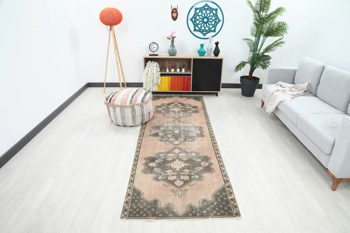 Anatolian runner rug in a modern living space, showing its full length and rose and charcoal colors