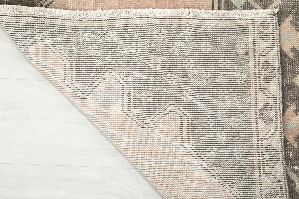 Close-up of the back of the rug, showing the dense cotton foundation and hand-knotted construction
