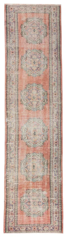 Full top view of the rust and blue geometric medallion vintage runner rug
