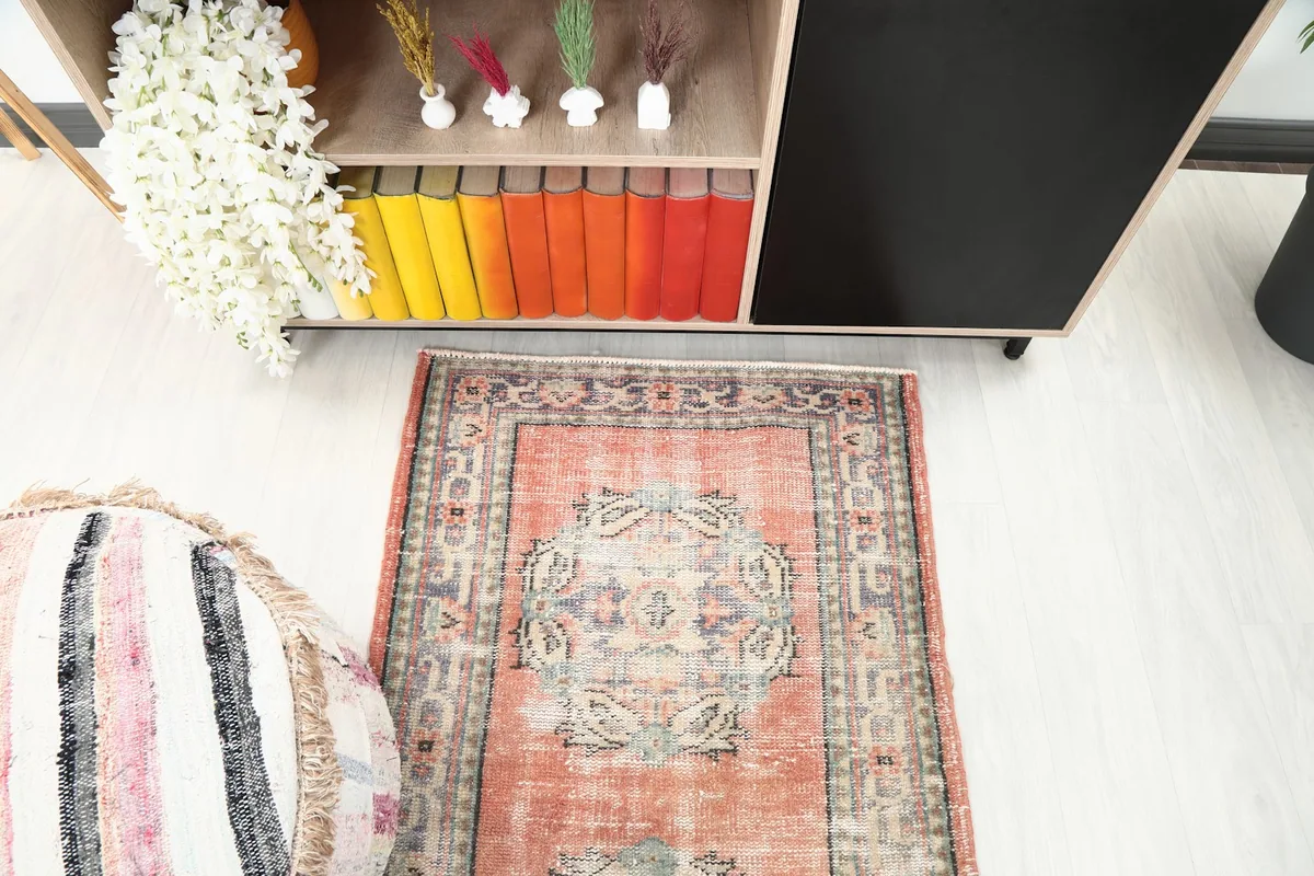Angled overhead view of one end of the runner rug in a room, showing its medallion pattern