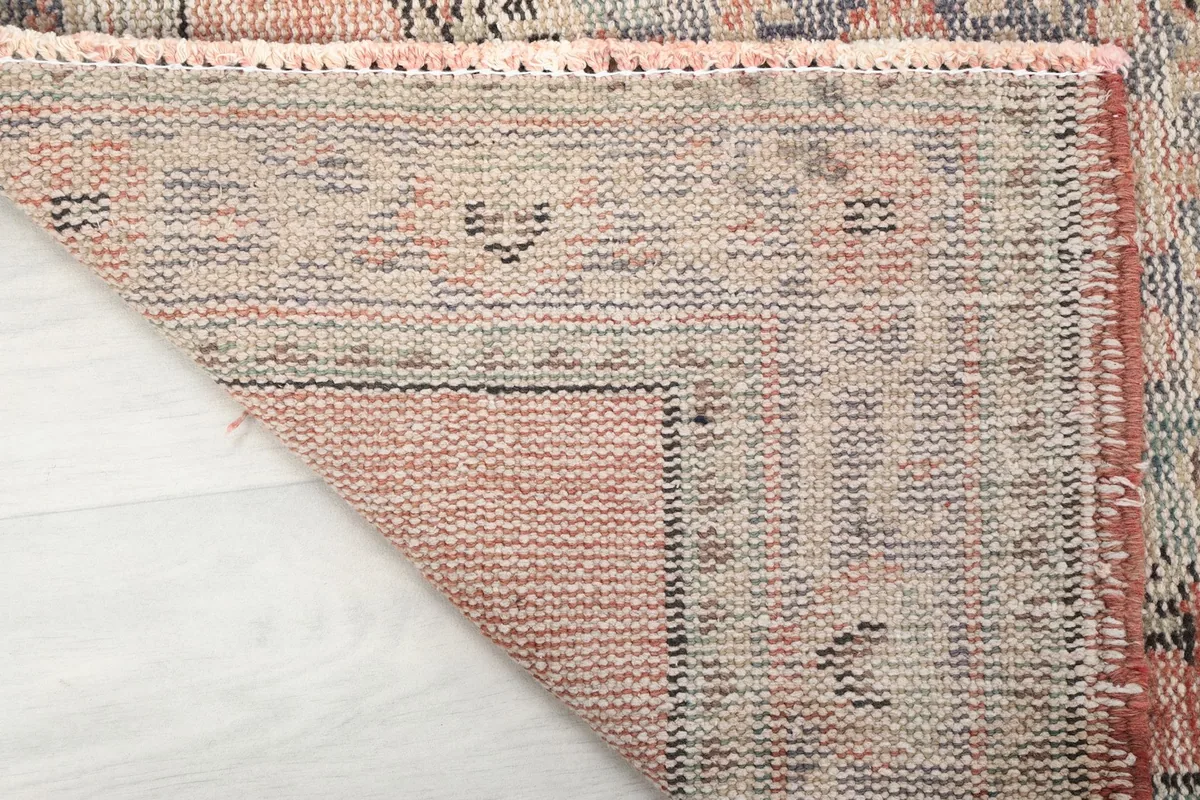 Close-up view of the back of the hand-knotted wool rug, showing its construction