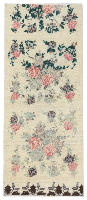 Full top view of the 2'6" x 6'3" ivory vintage Anatolian runner with rose and green floral patterns.