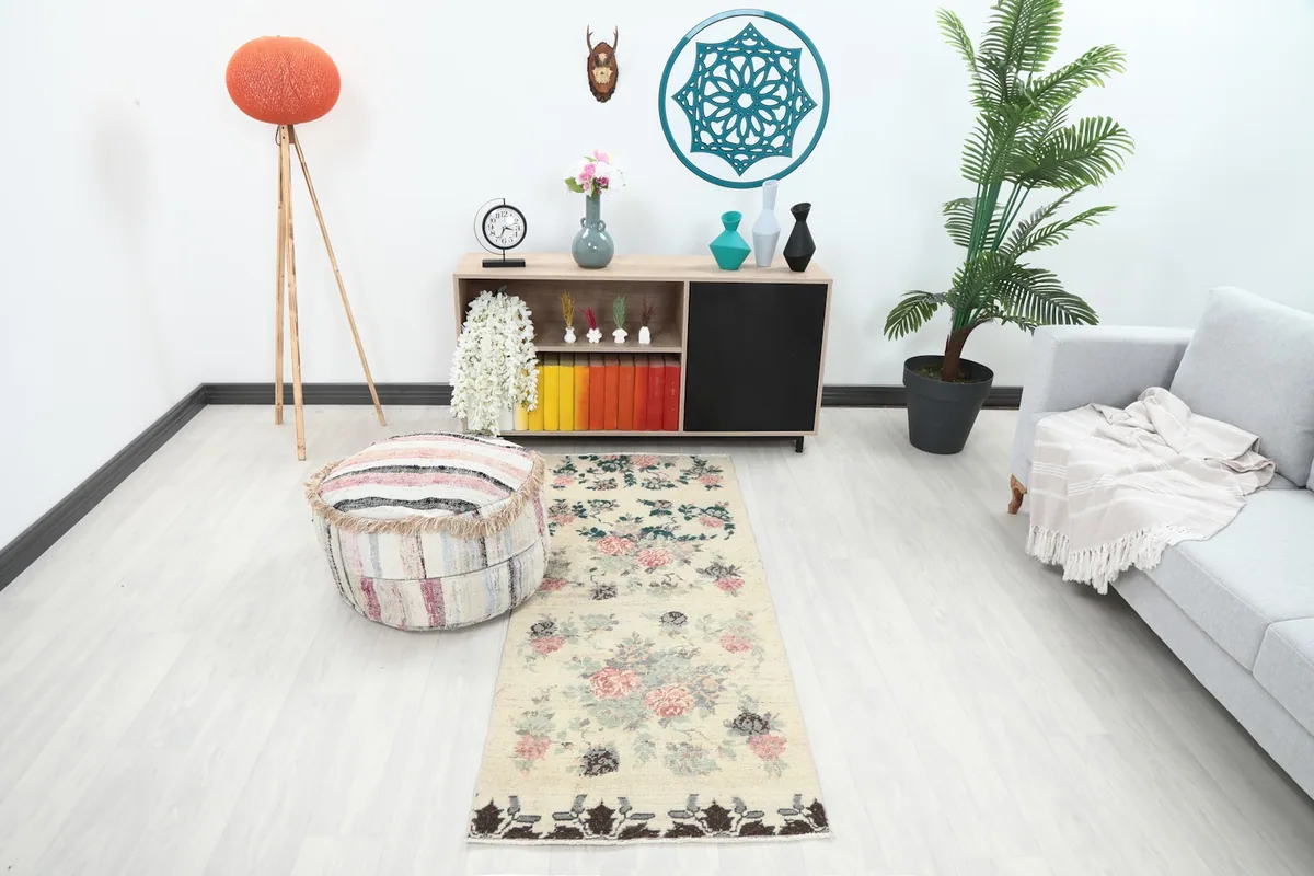 Ivory floral runner placed in a modern living space, showing its scale and design in context.