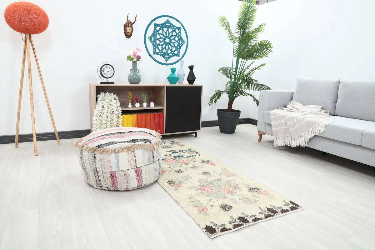 Angle view of the runner in a room, highlighting the blend of ivory, rose, and green colors.