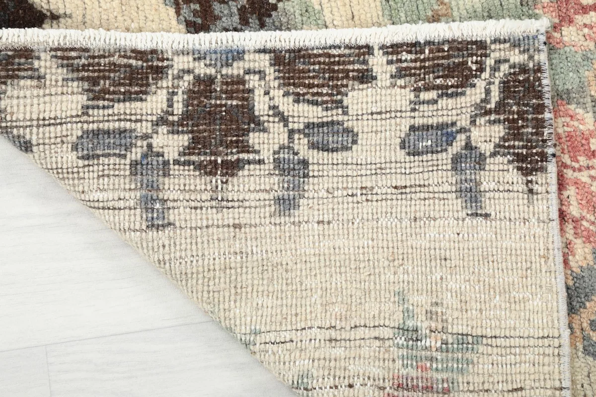 Underside of the rug, revealing the hand-knotted cotton foundation and weave structure.