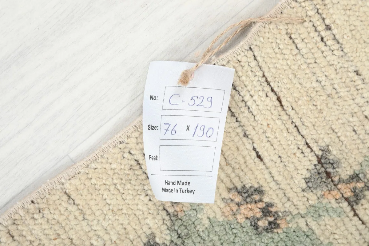 Close-up of the rug's tag, indicating its dimensions and origin from Turkey.