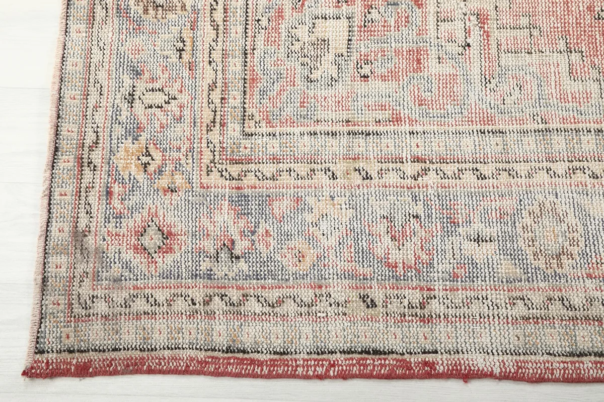 Detailed view of the outer border with intricate patterns and muted colors