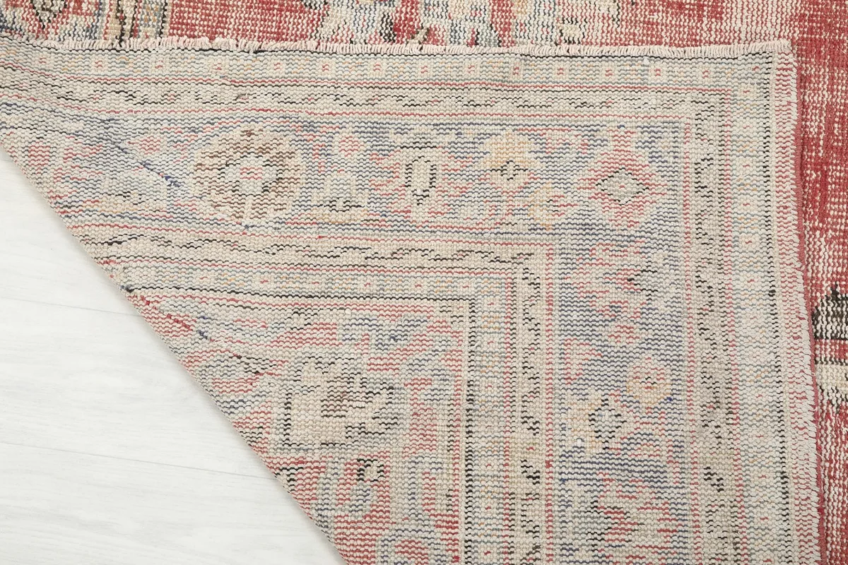 Close-up of the reverse side of the rug, revealing the hand-knotted cotton foundation