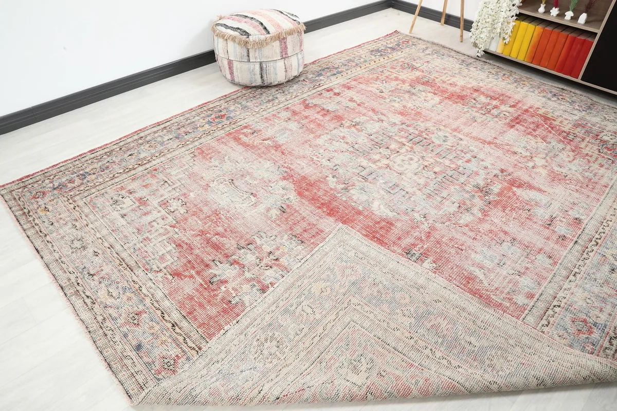 Corner of the rug folded back, showing the back of the rug and its construction