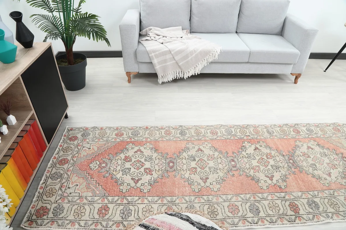 Overhead view of the runner rug in a room, showing its pattern and colors in context with surrounding furniture.