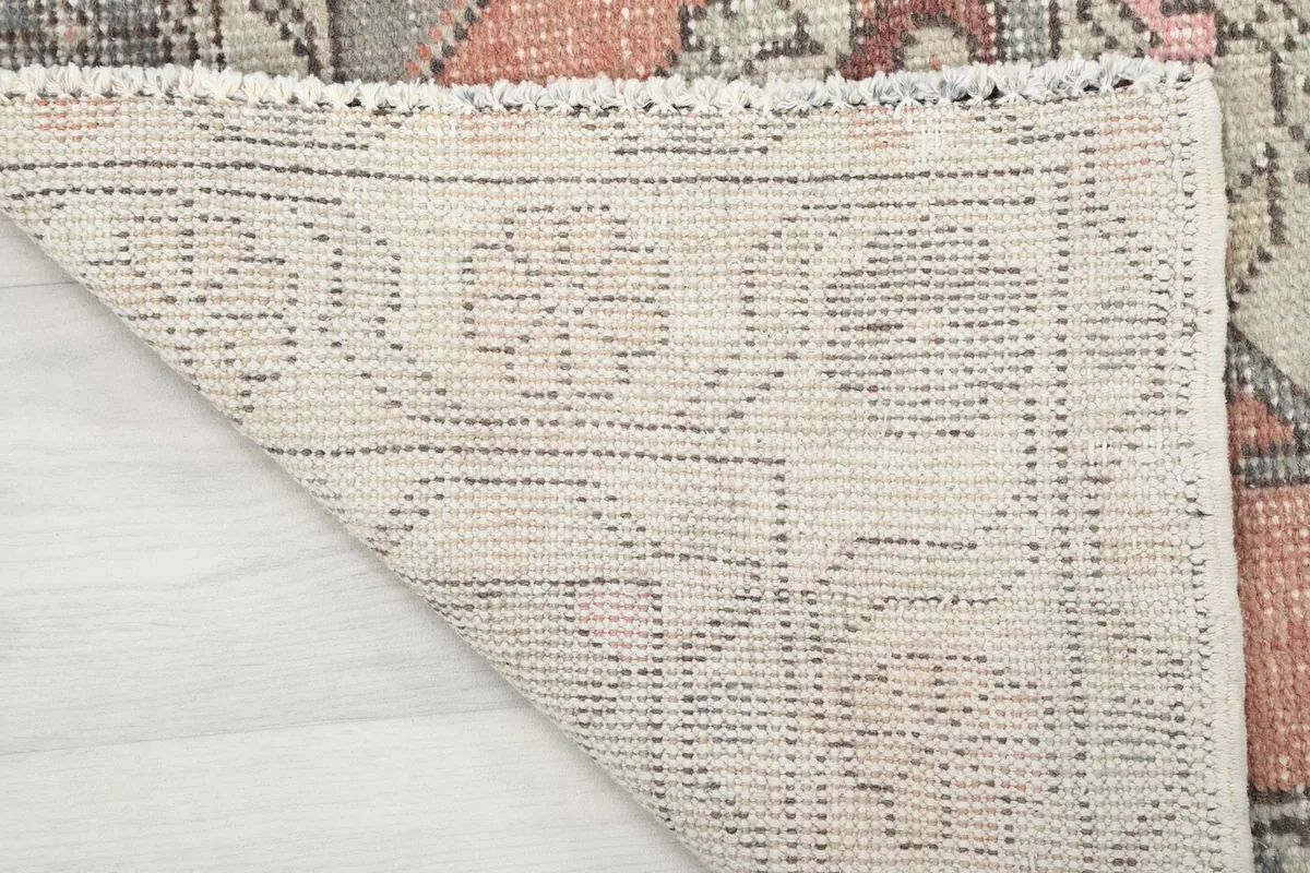 Underside view of the hand-knotted cotton foundation, showing the craftsmanship of the rug.