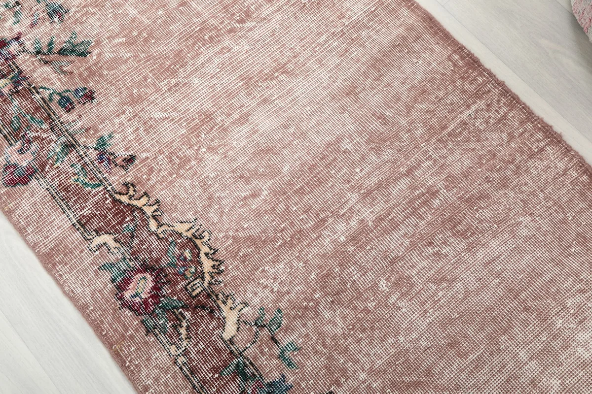 Detailed view of the rose field and intricate floral patterns within the rug's border