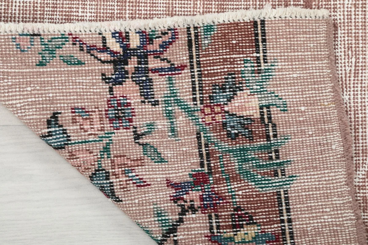 Close-up of the back of the rug, revealing the hand-knotted cotton foundation and weave