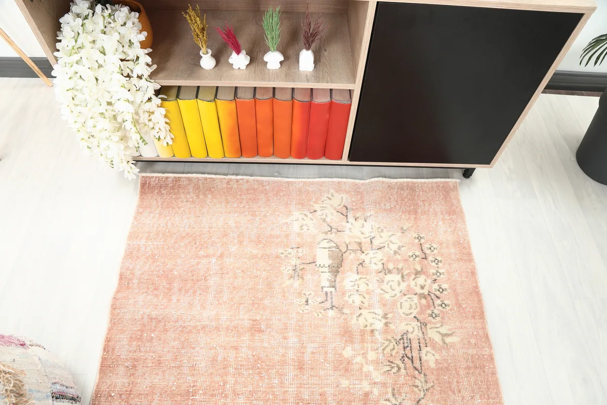 Detailed angle shot of the Faded Rose Floral Anatolian Rug, focusing on the upper floral pattern.