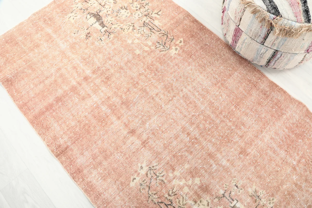 Close-up detail of the Faded Rose Floral Anatolian Rug's faded rose pile and cream floral design.
