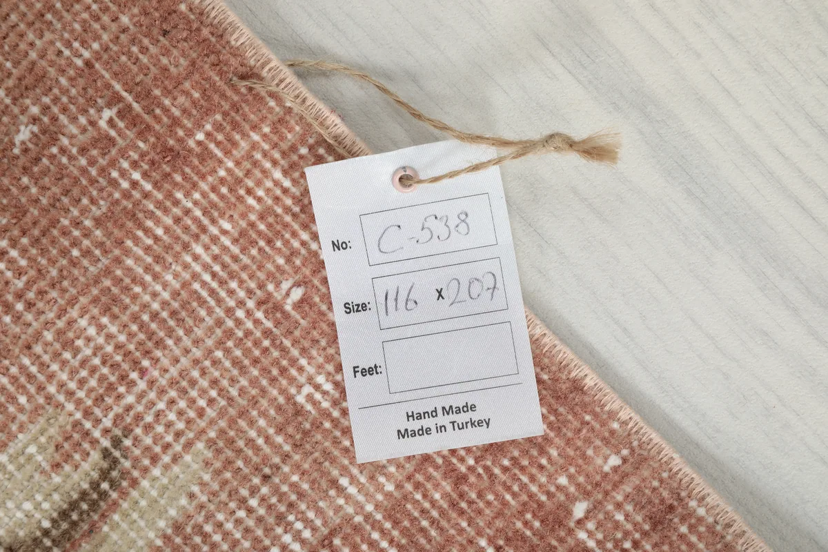 Tag on the Faded Rose Floral Anatolian Rug displaying its unique identifier and size in centimeters.