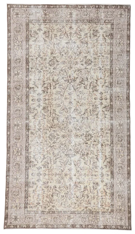 Full top view of the 4'10" x 8'7" cream and brown floral Anatolian rug on a white background.