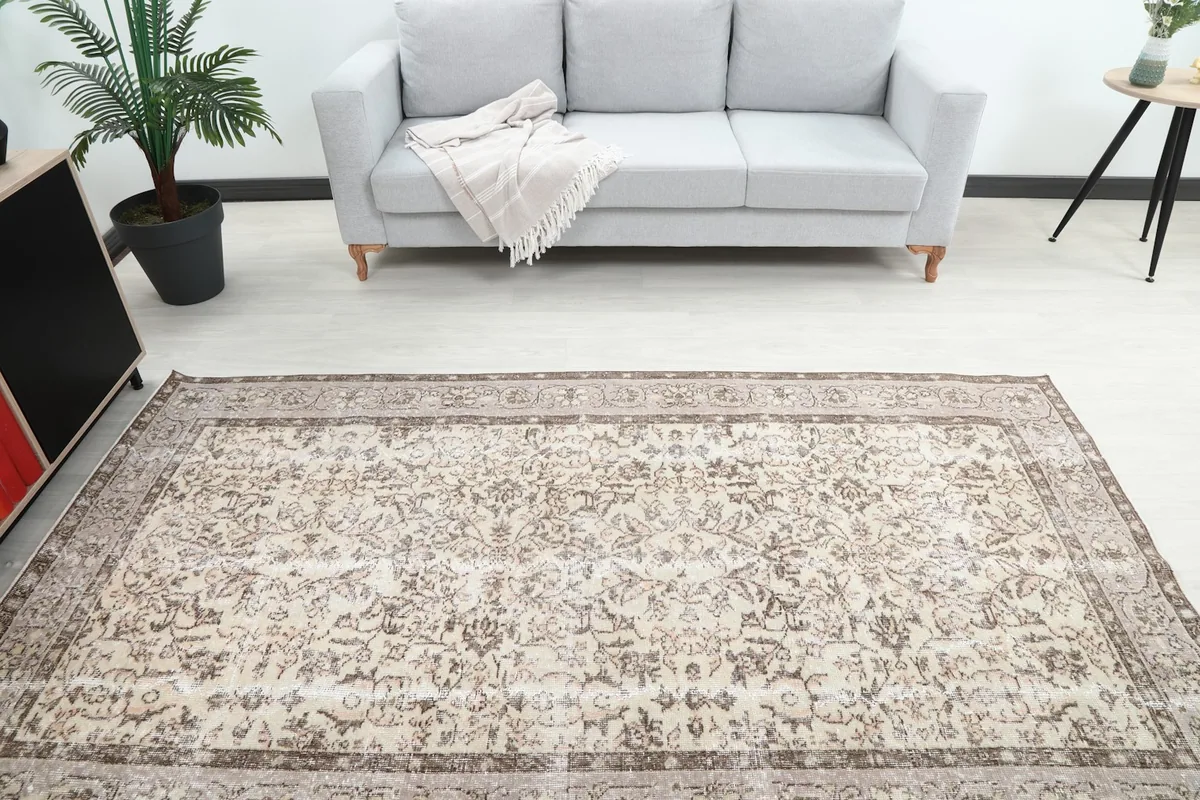 Overhead view of the rug in a living room, positioned in front of a light gray sofa.