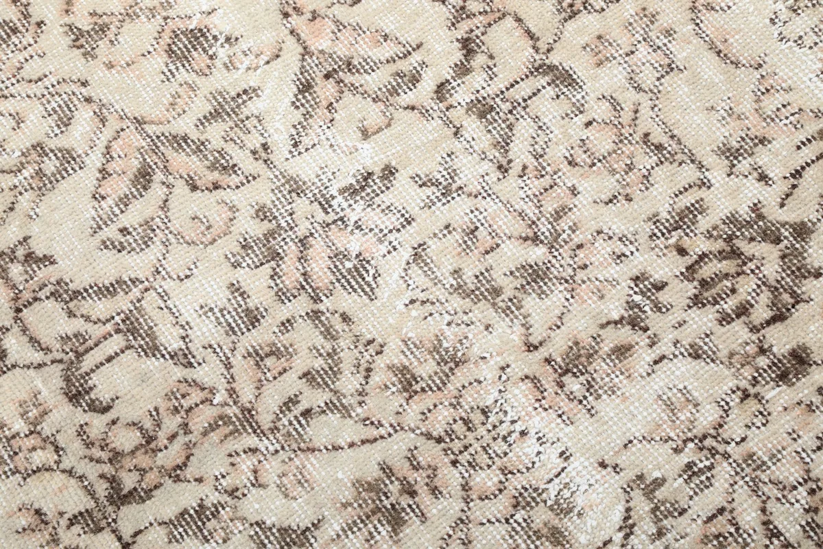 Detailed view of the low wool pile, highlighting the subtle color variations and hand-knotted texture.