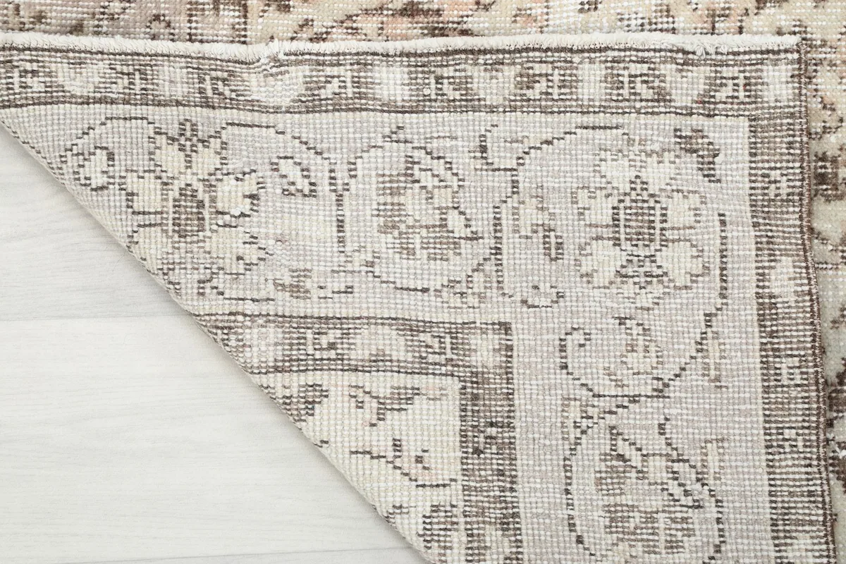 Close-up of the rug's reverse side, showcasing the hand-knotted wool pile on cotton foundation.