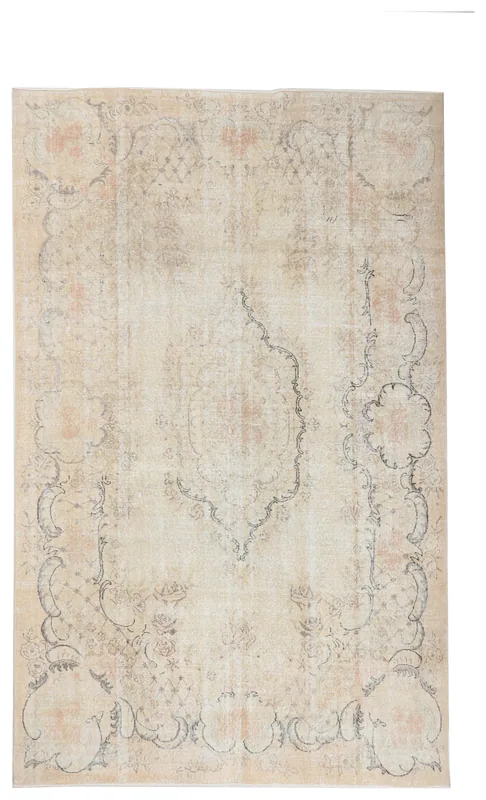 Full overhead view of a beige and cream vintage Anatolian rug with a central medallion and floral patterns