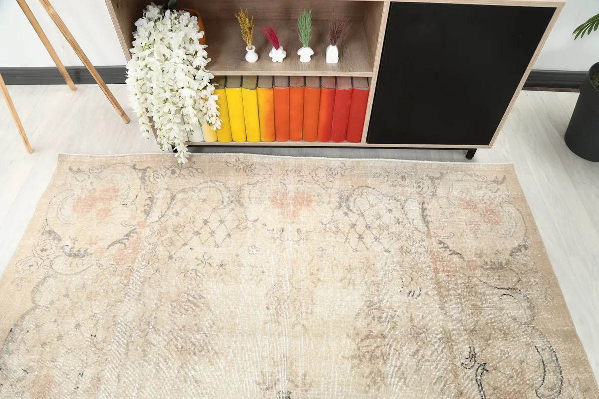 Angled view focusing on the upper portion of the rug, highlighting the subtle rose and gray tones