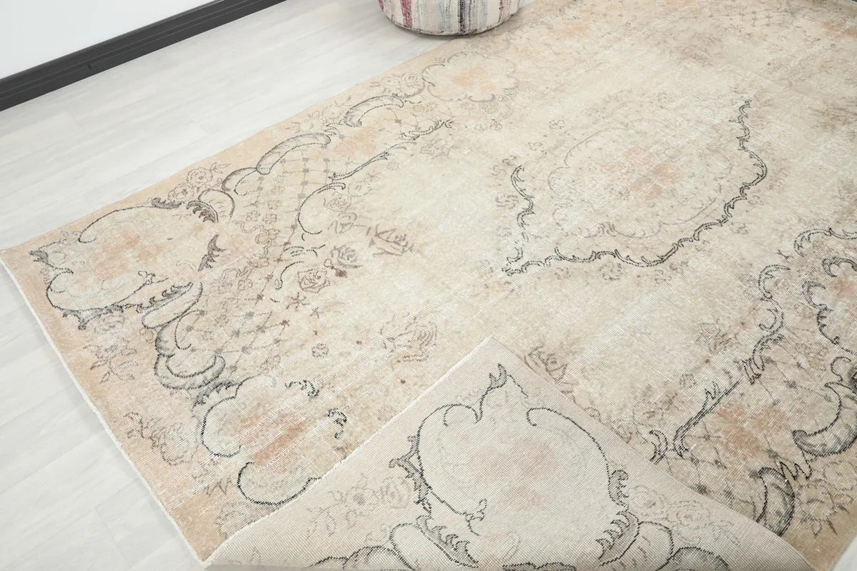 View of the rug with a corner folded back, revealing the reverse side and construction
