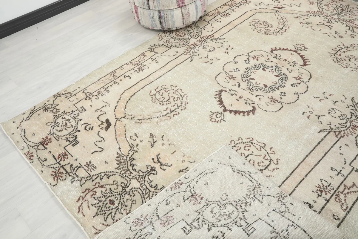 Diagonal view of the rug, emphasizing its texture and the aged appearance of the wool