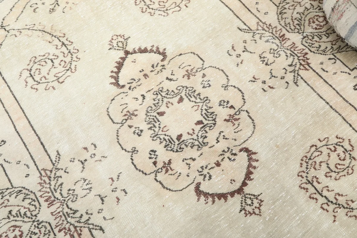 Close-up of the central medallion motif with brown and rust colored details