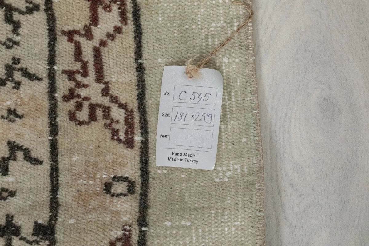 Back of the rug showing the care tag with dimensions and 'Hand Made in Turkey' label