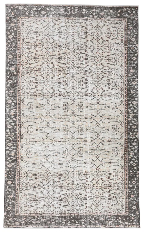 Full overhead view of the vintage Anatolian rug with ivory field and charcoal border.