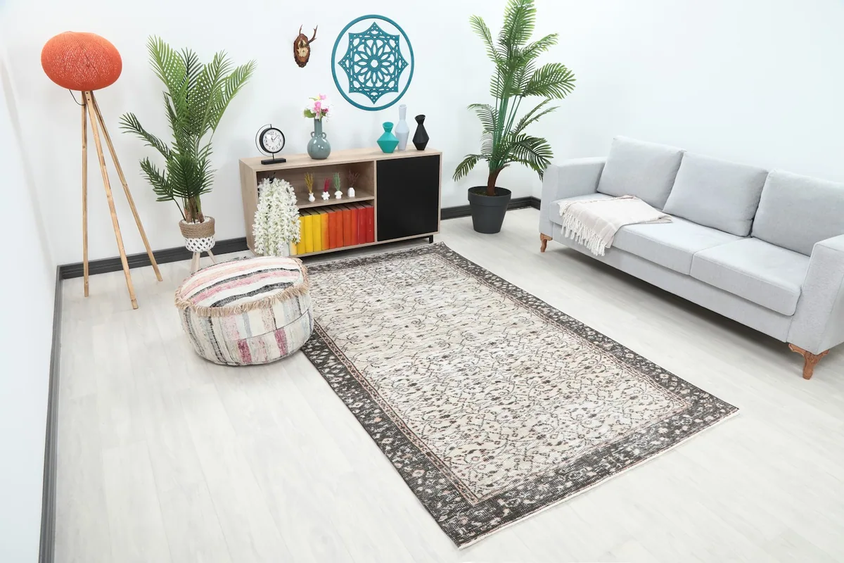 Angled view of the rug in a living space, showing its size relative to furniture.