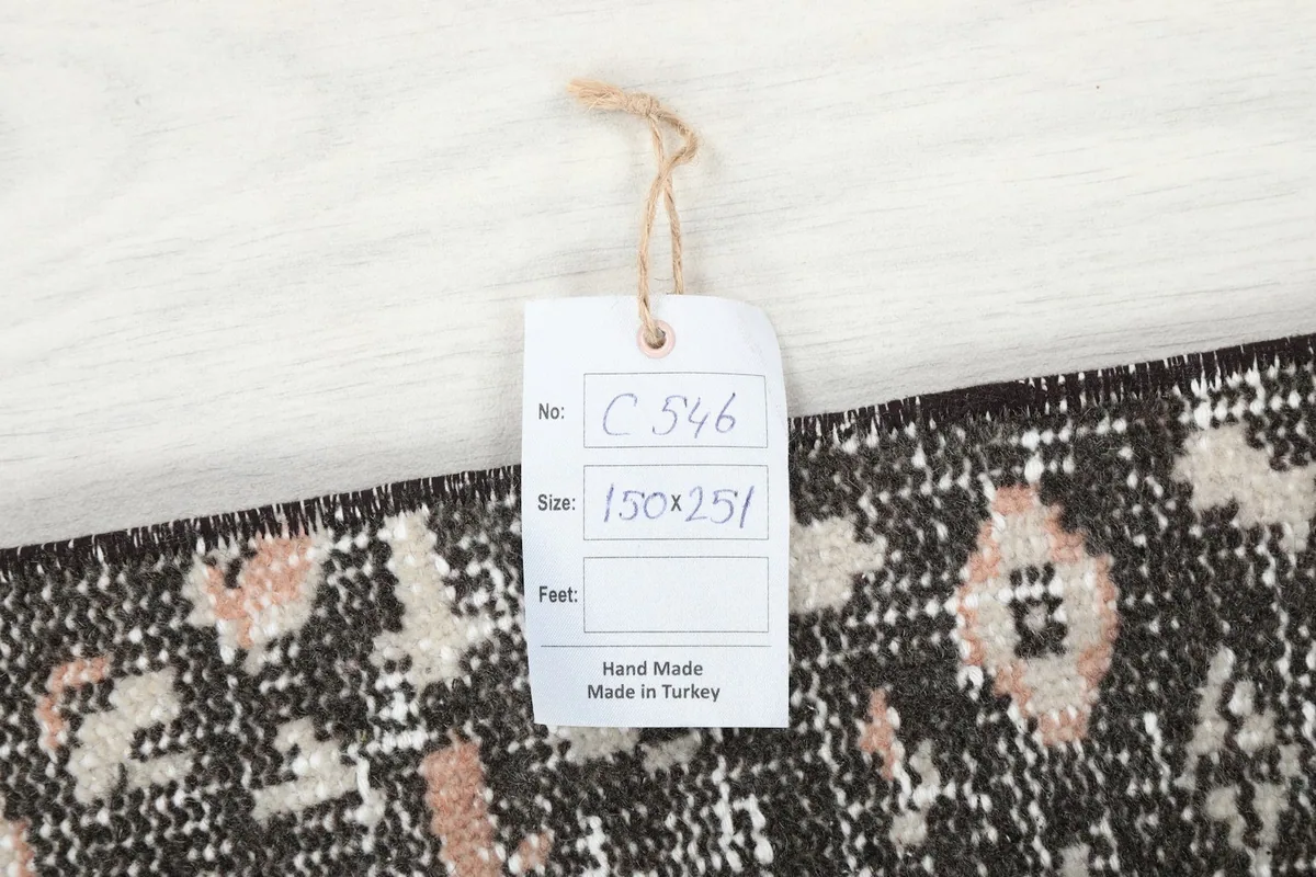 Tag displaying the rug's item number and dimensions in centimeters, confirming its origin.