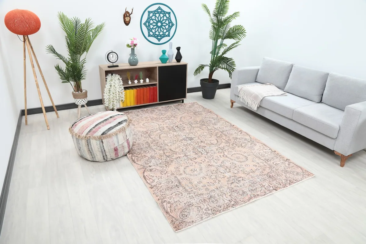 Overhead angle of the rose and gray rug in a living room, showing its placement relative to furniture