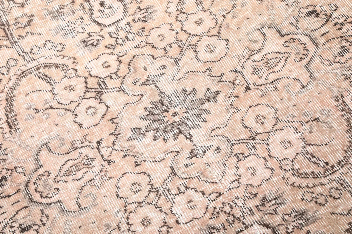 Close-up of the central medallion and surrounding floral details in gray and charcoal tones