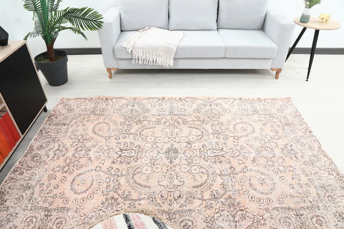 Overhead view of the vintage rose rug, highlighting its central medallion and overall pattern